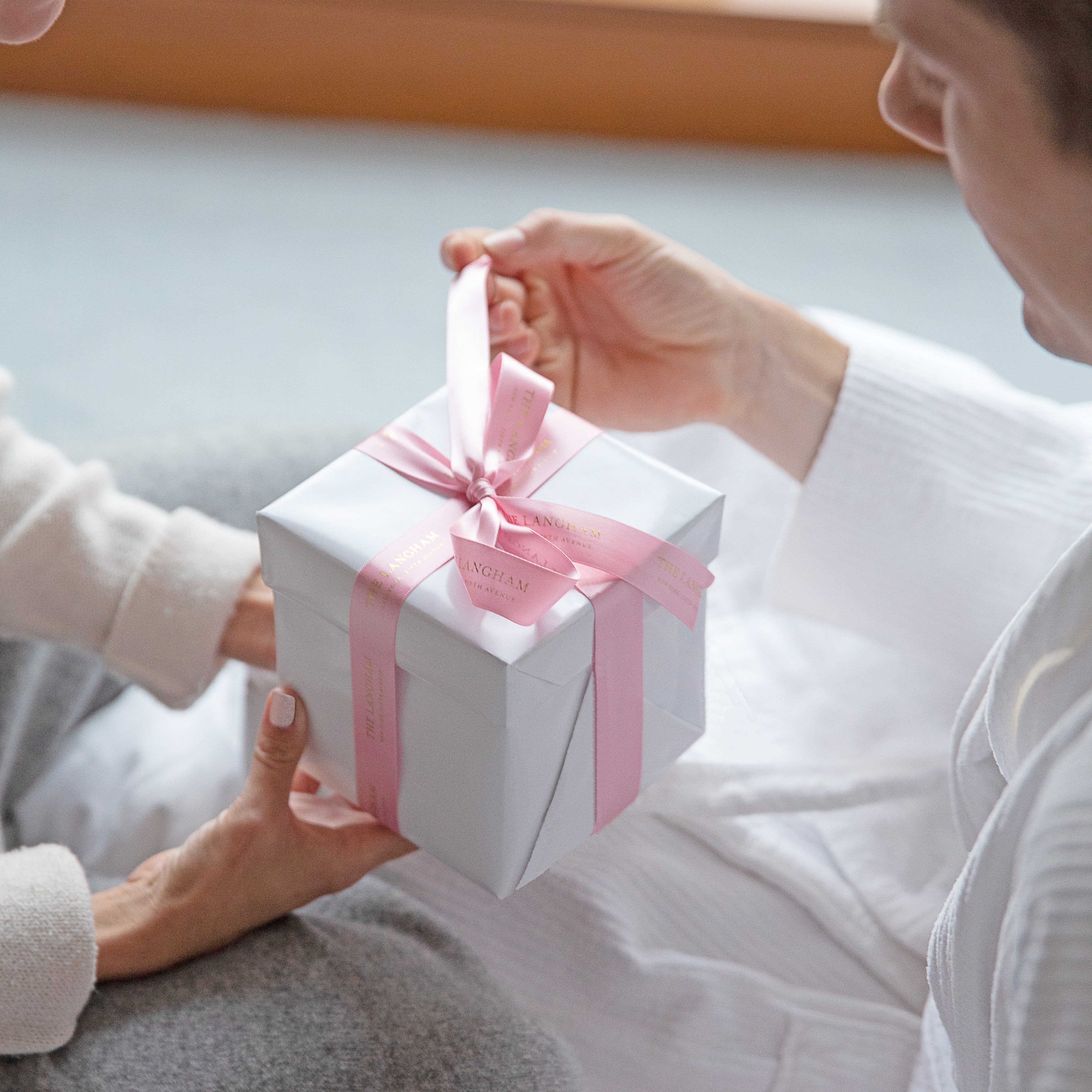 Couple exchanging a gift from The Langham